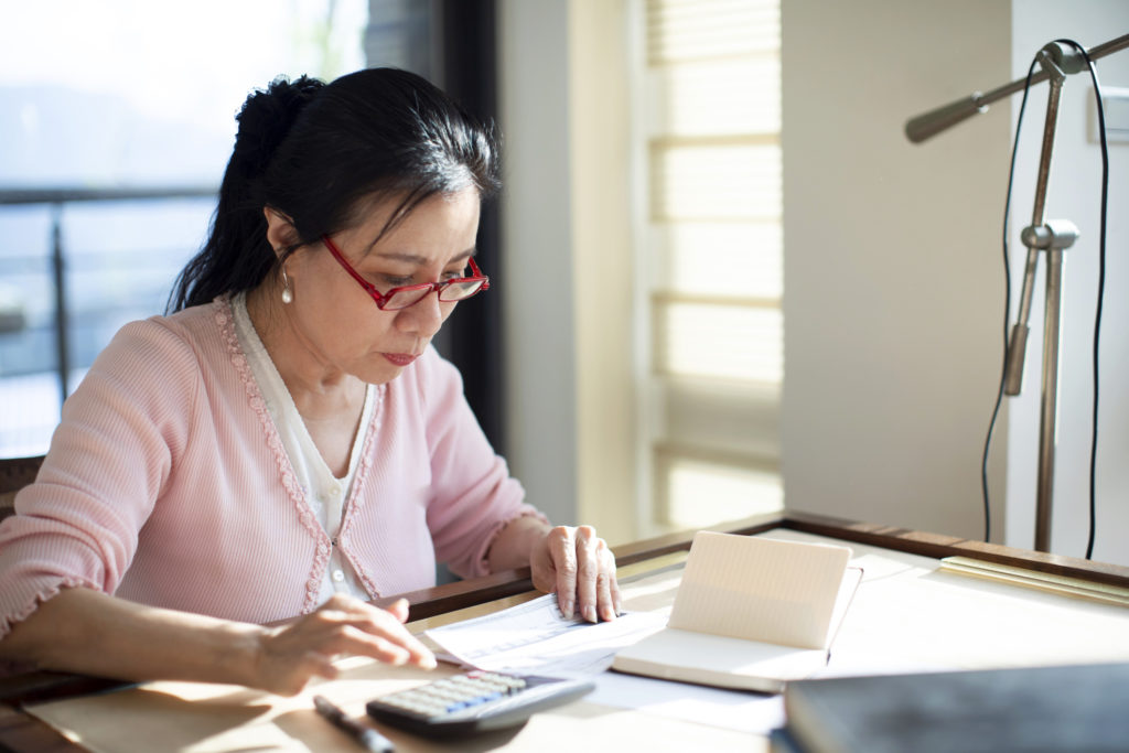 woman at desk working on retirement income planning