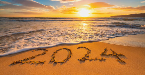 CWT Newsletter Q1 2024 - image of a sunset on the beach with 2024 drawn in the sand